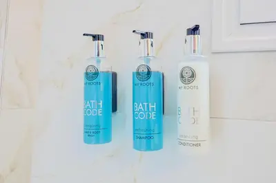 three bottles of hair dye sitting on a counter at Faliron Urban Retreat in Athens