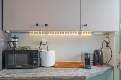 a kitchen counter with a microwave and a toaster oven at Faliron Urban Retreat in Athens