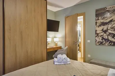 a bedroom with a bed with a pair of shoes on it at Acropolis Compass Residence in Athens