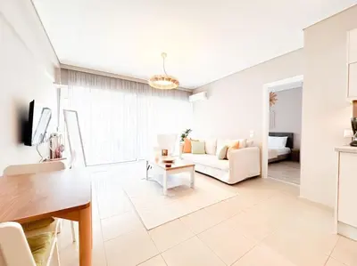 a living room with a couch and a table at Pame Rentals - Chic Alimos Home, 5 Min Walk to the Beach in Athens