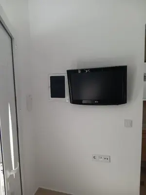 a flat screen tv on top of a white wall at Athens LUXURY STUDIO 1 in Athens