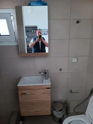 a man taking a picture of a bathroom mirror at Athens LUXURY STUDIO 1 in Athens