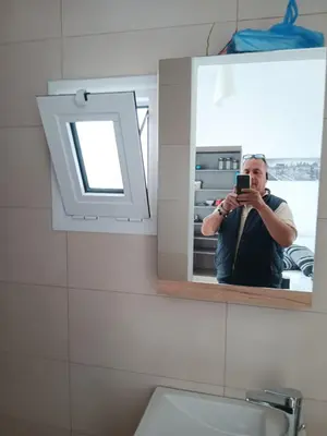 a man taking a picture of himself in a bathroom mirror at Athens LUXURY STUDIO 1 in Athens