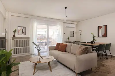 a living room with a couch and a table at Modern Escape 2BR Apartment in Glyfada by UPSTREET in Athens