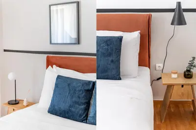 a bedroom with a bed with blue and white pillows at Modern Escape 2BR Apartment in Glyfada by UPSTREET in Athens