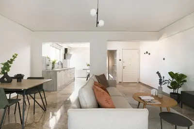 a living room with a couch and a table at Modern Escape 2BR Apartment in Glyfada by UPSTREET in Athens