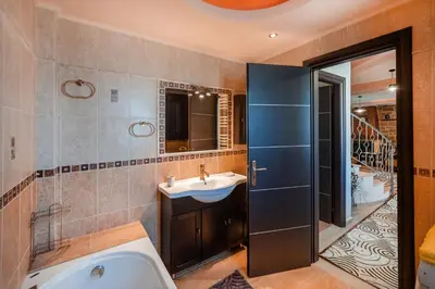a bathroom with a tub and a sink and a shower at Perfect House in Spata in Spáta