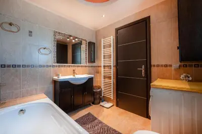 a bathroom with a tub and a sink at Perfect House in Spata in Spáta