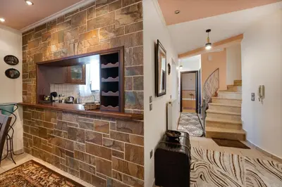 a room with a brick wall and a staircase at Perfect House in Spata in Spáta