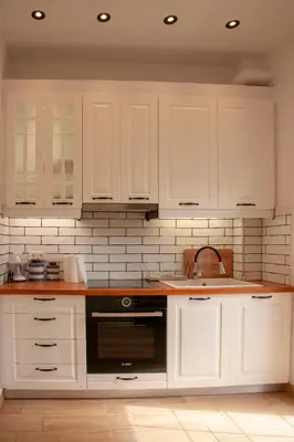 a kitchen with white cabinets and a sink at Raise Varkiza Serenity Suite in Vari