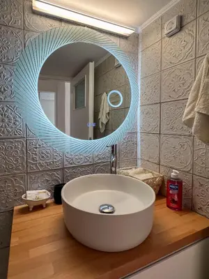 a bathroom with a sink and a large mirror at Raise Varkiza Serenity Suite in Vari
