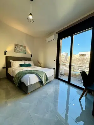 a bedroom with a bed and a large window at Kozy Koala Apartments, n21, Near Akropolis in Athens