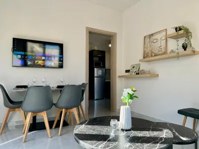 a living room with a table and chairs at Kozy Koala Apartments, n21, Near Akropolis in Athens