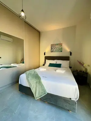 a bedroom with a large white bed with a large mirror at Kozy Koala Apartments, n21, Near Akropolis in Athens