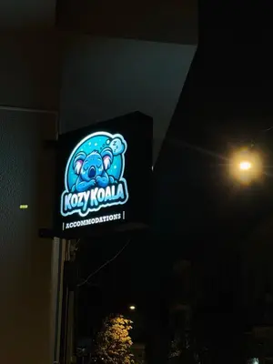 a sign on the side of a building at night at Kozy Koala Apartments, n21, Near Akropolis in Athens