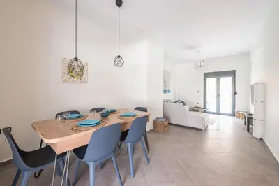 a kitchen and dining room with a table and chairs at Sempre il Mare in Piraeus