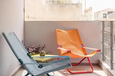 an orange chair sitting on a balcony at Sempre il Mare in Piraeus