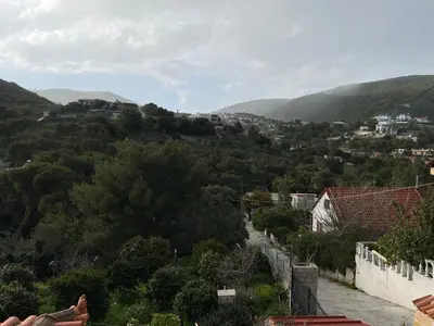 a view of a hill with houses and trees at Filoxenia Harmony Retreat in Keratea