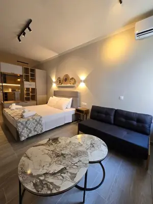 a bedroom with a bed and a couch and a table at Órrhaon Athens in Athens