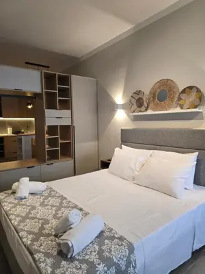 a bedroom with a large bed with towels on it at Órrhaon Athens in Athens