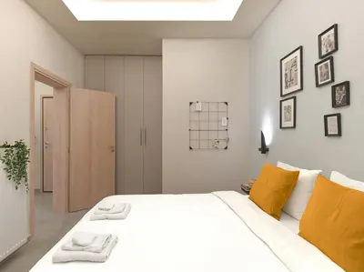 a bedroom with a large white bed with yellow pillows at Formionos95 in Athens