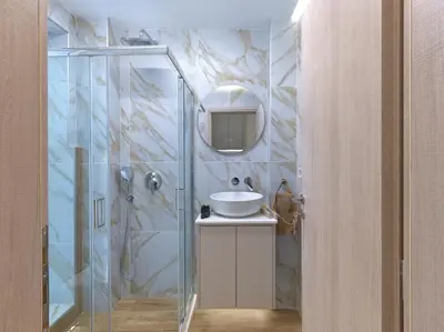 a bathroom with a glass shower and a sink at Formionos95 in Athens
