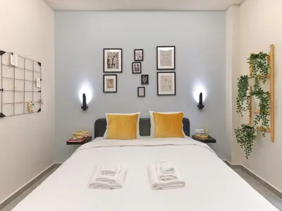 a bedroom with a large white bed with orange pillows at Formionos95 in Athens