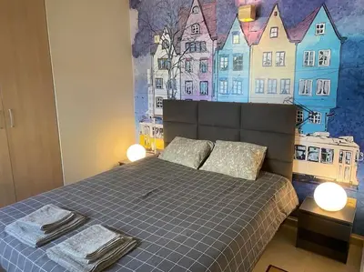 a bedroom with a bed with a painting on the wall at Porto - luxury penthouse, pool, walk to the beach in Porto Rafti