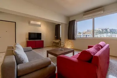 a living room with two couches and a tv at Happy Loft Athens in Athens