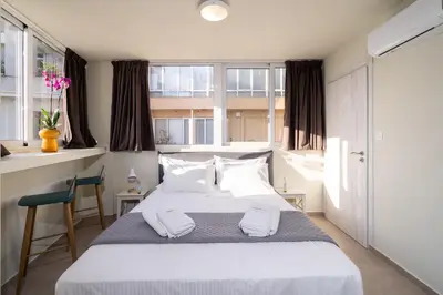 a bedroom with a bed with two towels on it at Happy Loft Athens in Athens