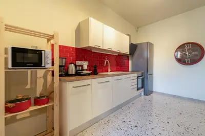 a kitchen with white cabinets and a sink and a microwave at Happy Loft Athens in Athens