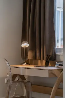 a desk with a laptop on it next to a window at Happy Loft Athens in Athens