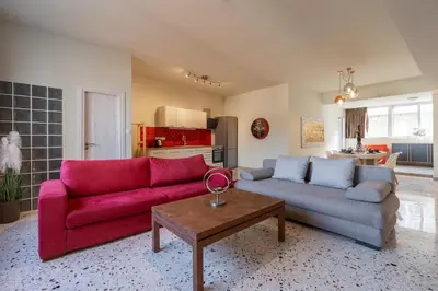 a living room with a red couch and a table at Happy Loft Athens in Athens