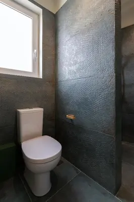 a bathroom with a toilet and a window at Happy Loft Athens in Athens
