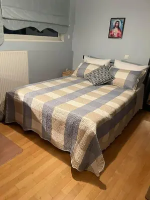 a bedroom with a bed with a checkered blanket at newly built apartment with amazing view in Athens