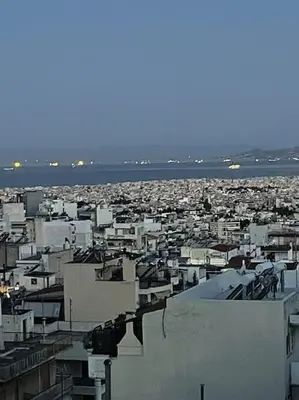 a view of a city with buildings and the water at newly built apartment with amazing view in Athens