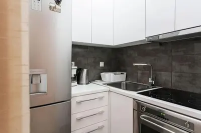 a kitchen with white cabinets and a sink at Flat in Athens historic city center @Ipitou str in Athens