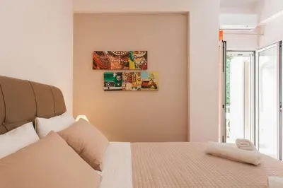 a bedroom with a white bed and a window at Flat in Athens historic city center @Ipitou str in Athens