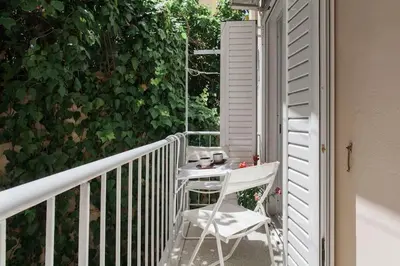 a balcony with a table and two chairs on a porch at Flat in Athens historic city center @Ipitou str in Athens