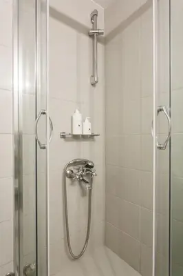 a bathroom with a shower with a glass door at Flat in Athens historic city center @Ipitou str in Athens