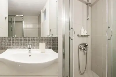 a bathroom with a sink and a shower at Flat in Athens historic city center @Ipitou str in Athens