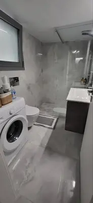 a white bathroom with a washing machine and a sink at Stella's Cozy Apt (By Marina Zeas) in Piraeus