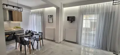 a kitchen and dining room with a table and chairs at Stella's Cozy Apt (By Marina Zeas) in Piraeus