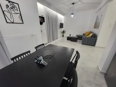 a black table and chairs in a living room at Stella's Cozy Apt (By Marina Zeas) in Piraeus