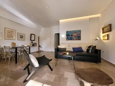 a living room with a couch and a table at Charming veranda in Exarcheia in Athens