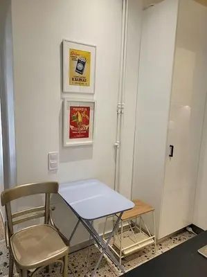 a table and a chair in a room at Charming veranda in Exarcheia in Athens
