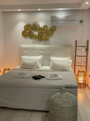 a bedroom with a large bed with plates on the wall at Kavouri Retreat, Only pines hide the sea in Athens
