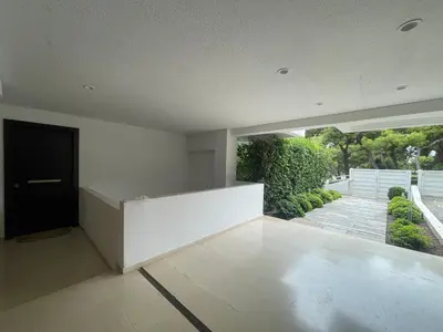an empty living room with a large window and a door at Kavouri Retreat, Only pines hide the sea in Athens