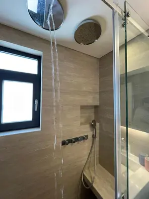 a shower in a bathroom with water pouring from the ceiling at Kavouri Retreat, Only pines hide the sea in Athens