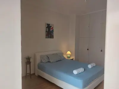 a small bedroom with a blue bed in a room at Penthouse Anneliese in Athens